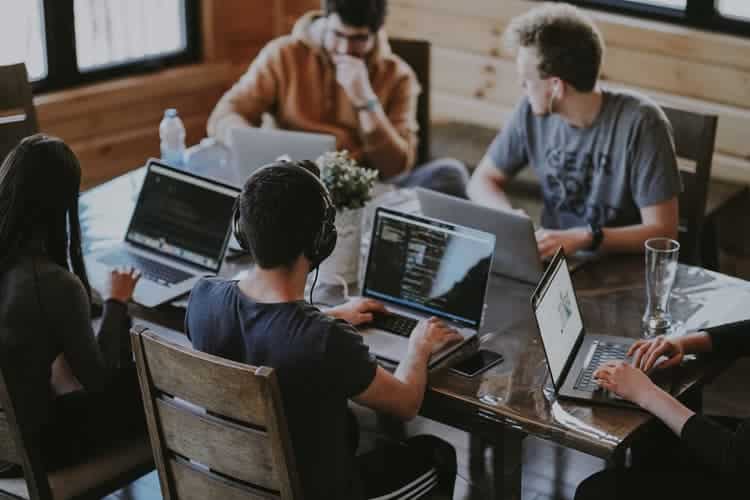 quatro devs programando e conversando