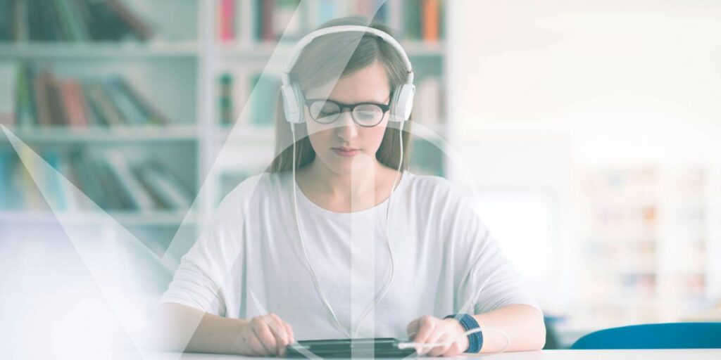 Jovem mulher com fones de ouvido e óculos estudando